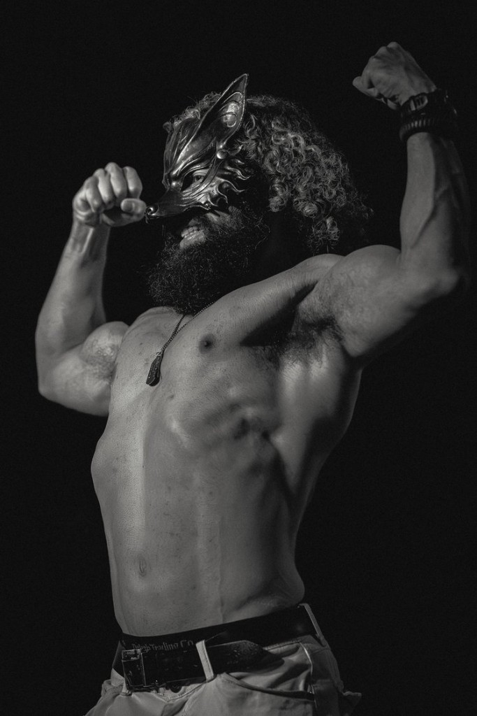 Ian flexing in a dramatic black-and-white portrait
