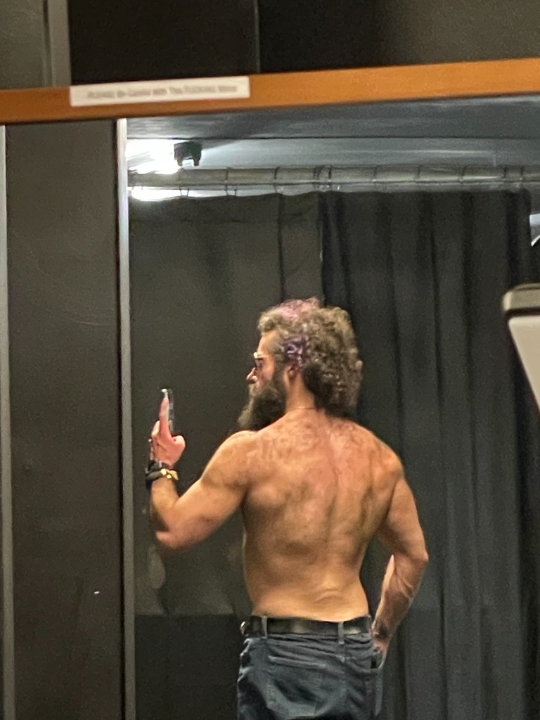 Ian back pose mirror selfie showing shoulder and back development