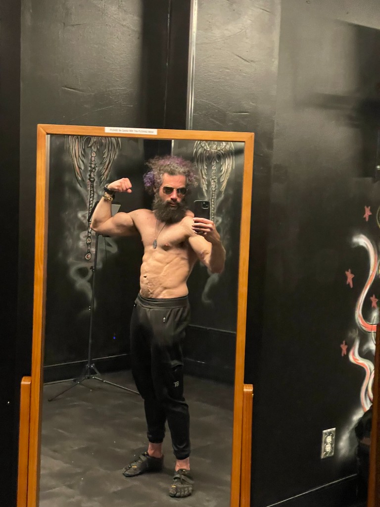Ian full-body mirror selfie in training room