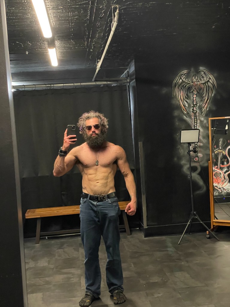 Ian front mirror selfie in gym setting